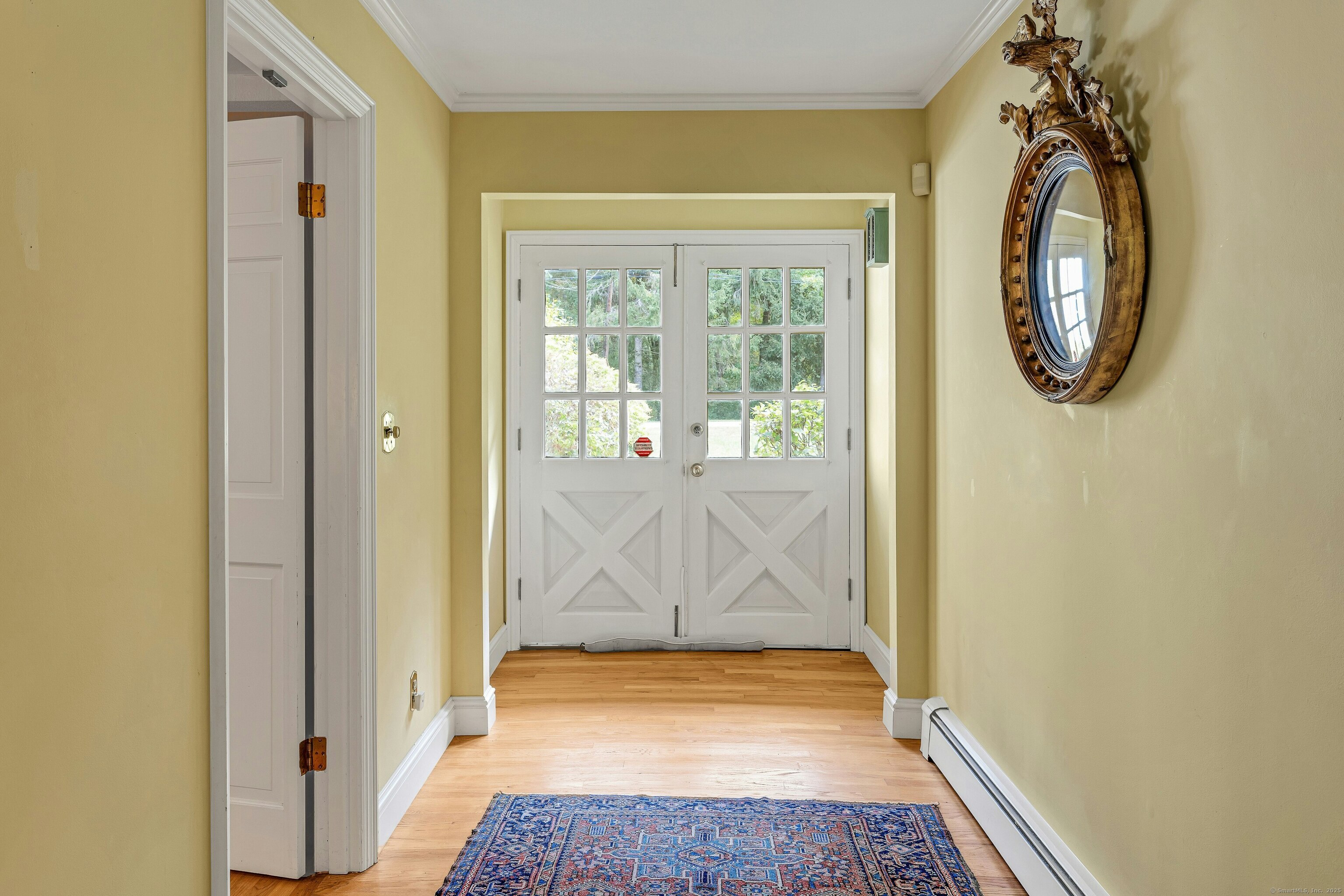 261 Linden Tree Road Wilton, CT 06897 - Photo 5 of 27 a view of a room that has a large window and wooden door