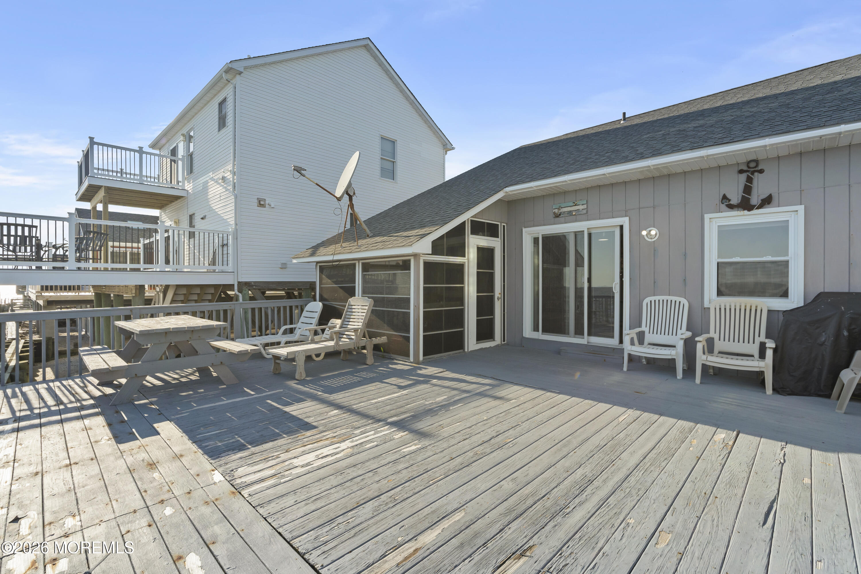 246 Cove Road Newport, NJ 08345 - Photo 18 of 21 a balcony with wooden floor and furniture