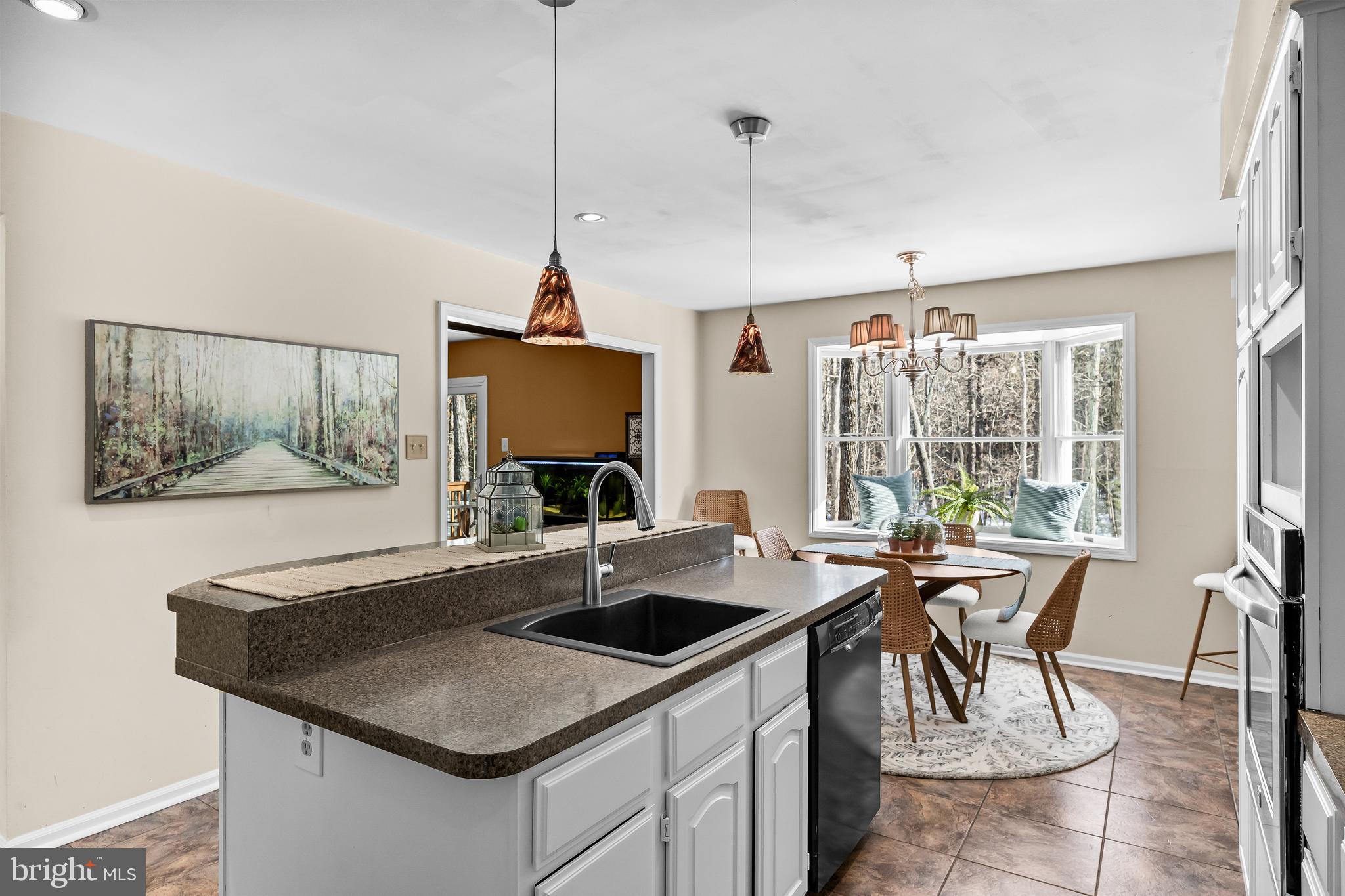 10 Lexington Court Shamong, NJ 08088 - Photo 11 of 47 a kitchen with a stove a sink a dining table and chairs