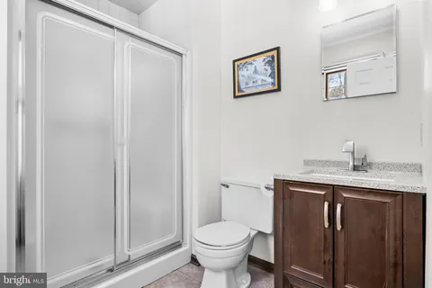 a bathroom with a toilet a sink and mirror