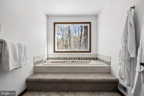 a bathroom with a bathtub and window