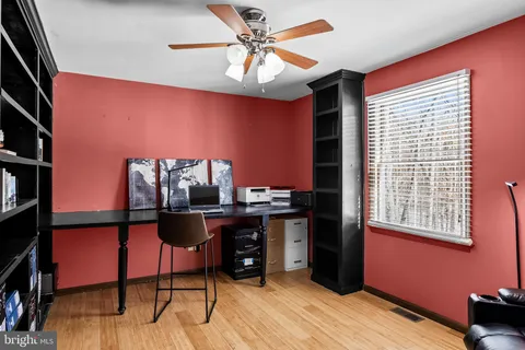 a view of a workspace with furniture and a window