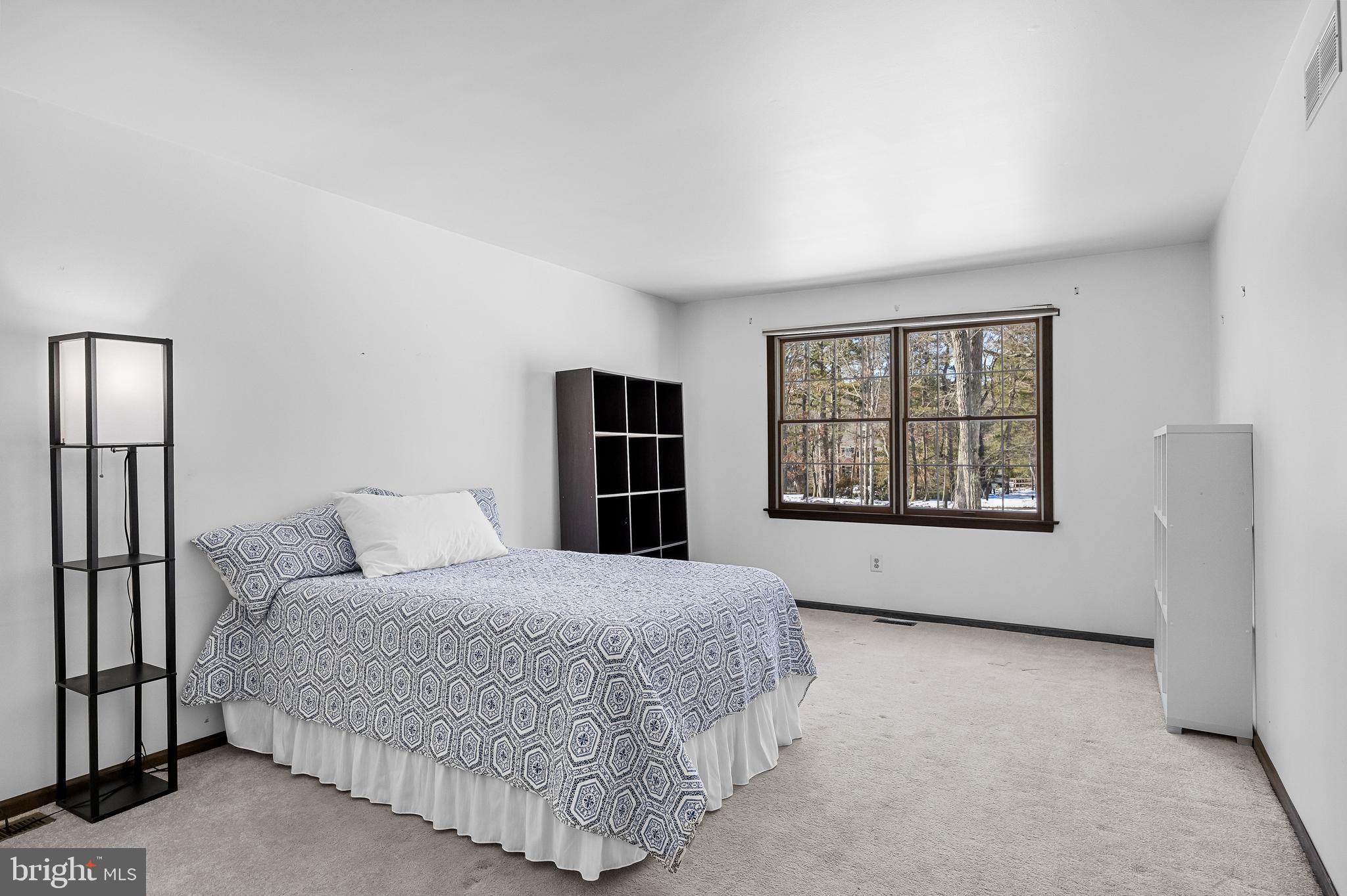 10 Lexington Court Shamong, NJ 08088 - Photo 33 of 47 a bedroom with a large bed and a window