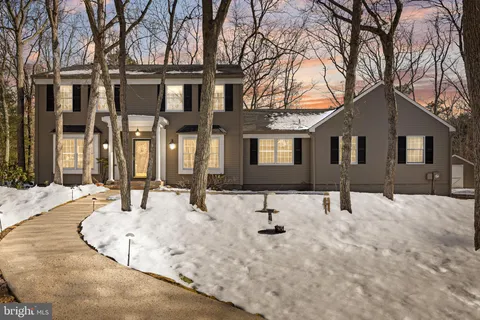 a view of a house with snow on the road