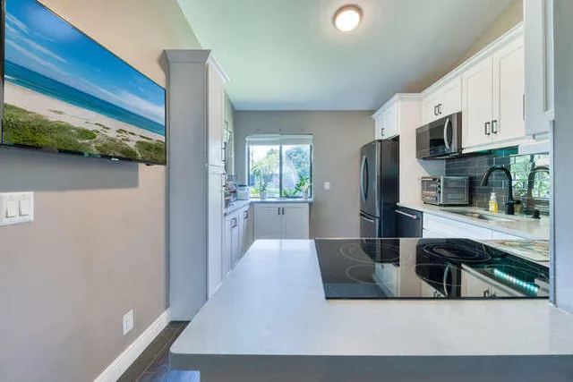 a kitchen with stainless steel appliances a refrigerator and a sink