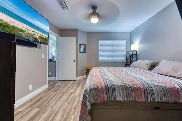 a bedroom with a bed and a chandelier