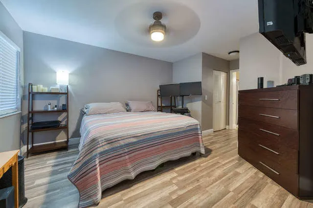 a bedroom with a bed and a table in it