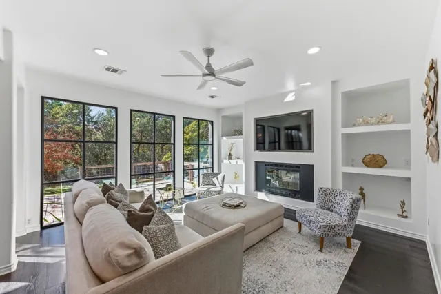 a living room with furniture fireplace and flat screen tv