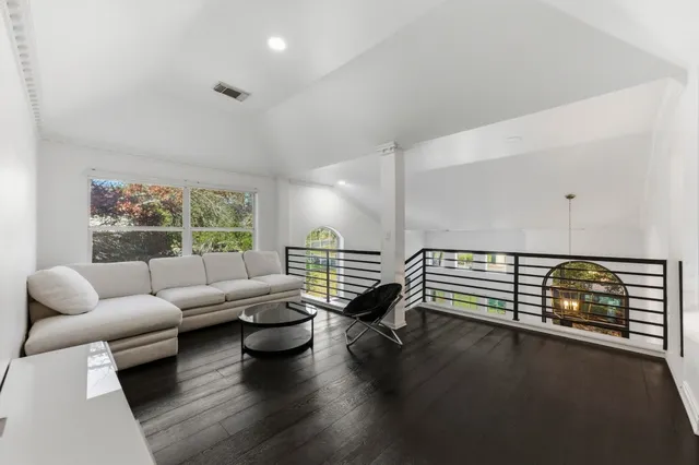 a living room with furniture and floor to ceiling window