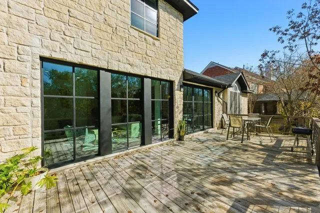 a view of house with backyard outdoor seating and deck