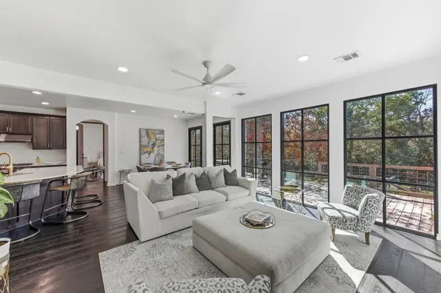 a living room with furniture and large windows