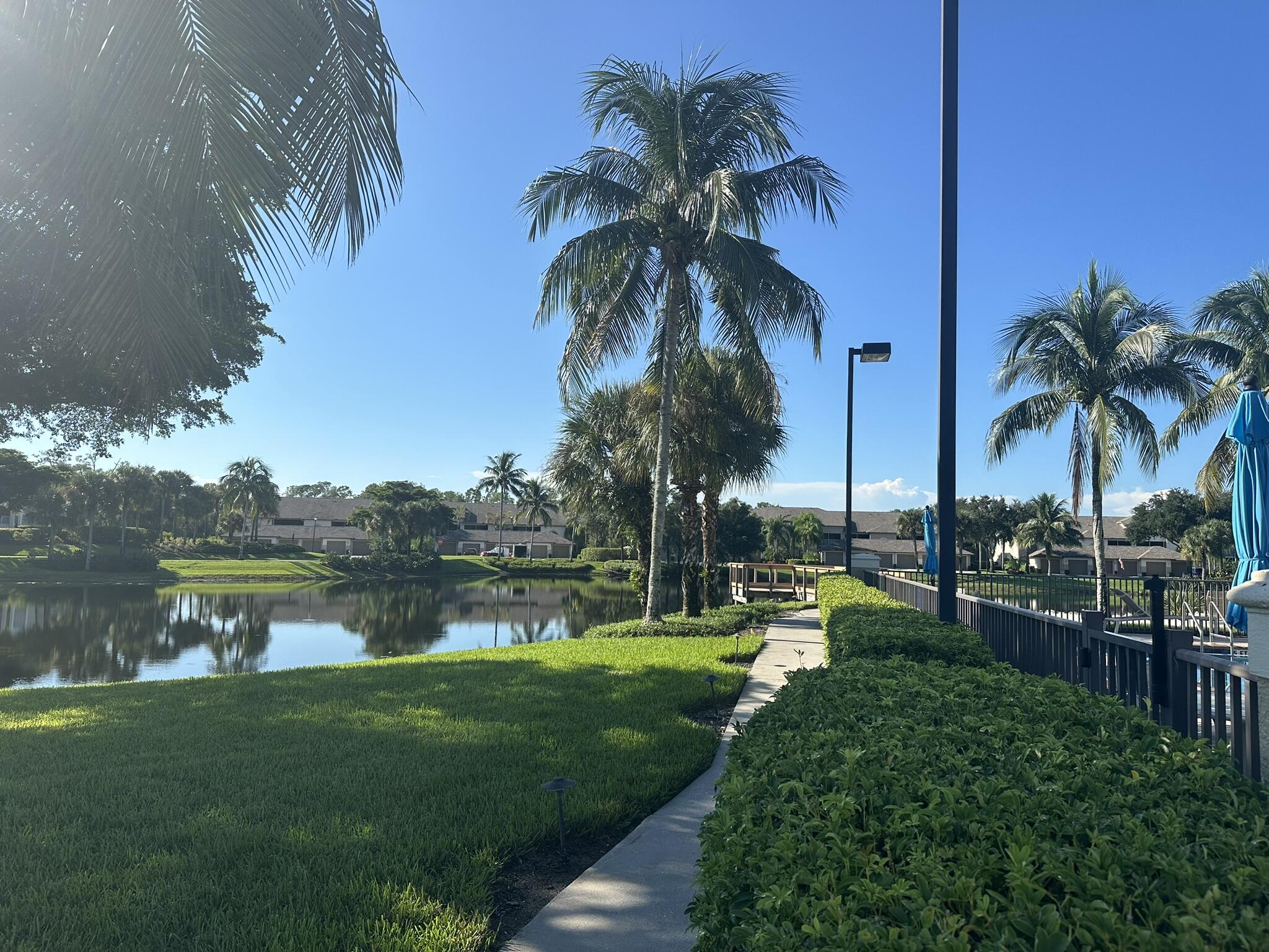 8660 Cedar Hammock Circle, Unit 314 Naples, FL 34112 - Photo 15 of 31 a view of a lake with a palm trees
