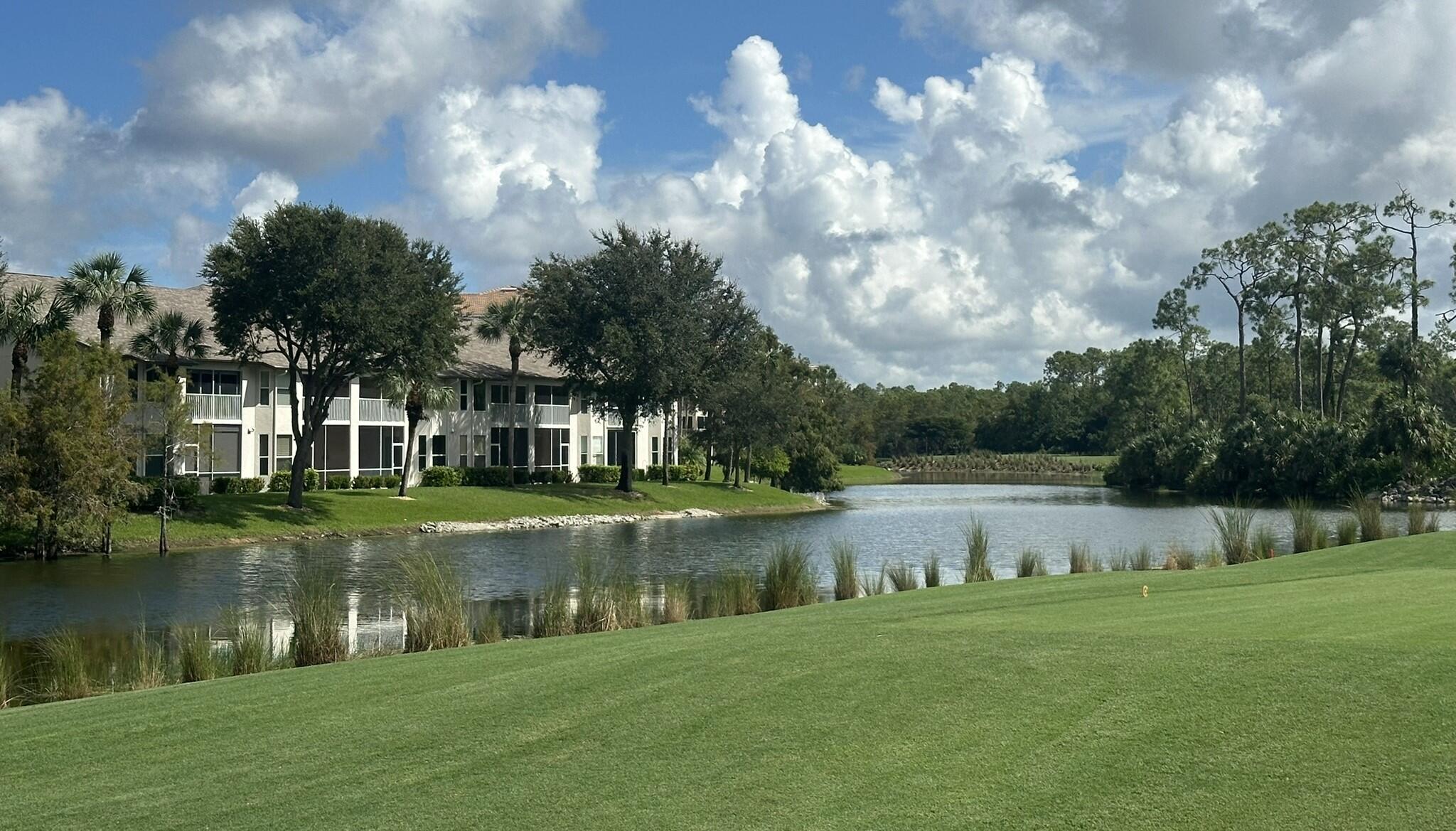 8660 Cedar Hammock Circle, Unit 314 Naples, FL 34112 - Photo 16 of 31 a view of a lake with a big yard