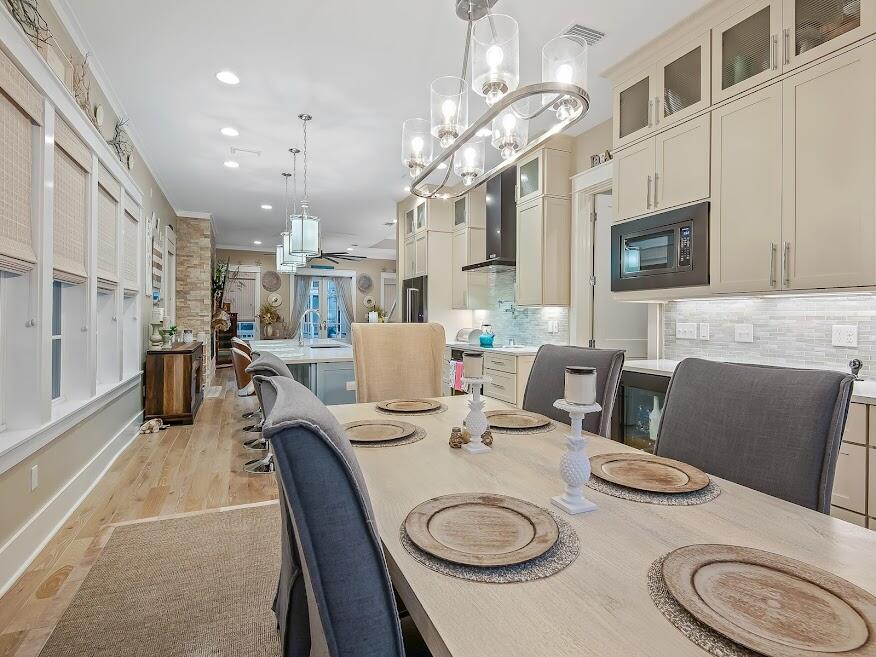 277 Matt's Way Santa Rosa Beach, FL 32459 - Photo 14 of 37 a dining room with furniture a kitchen a sink and a chandelier