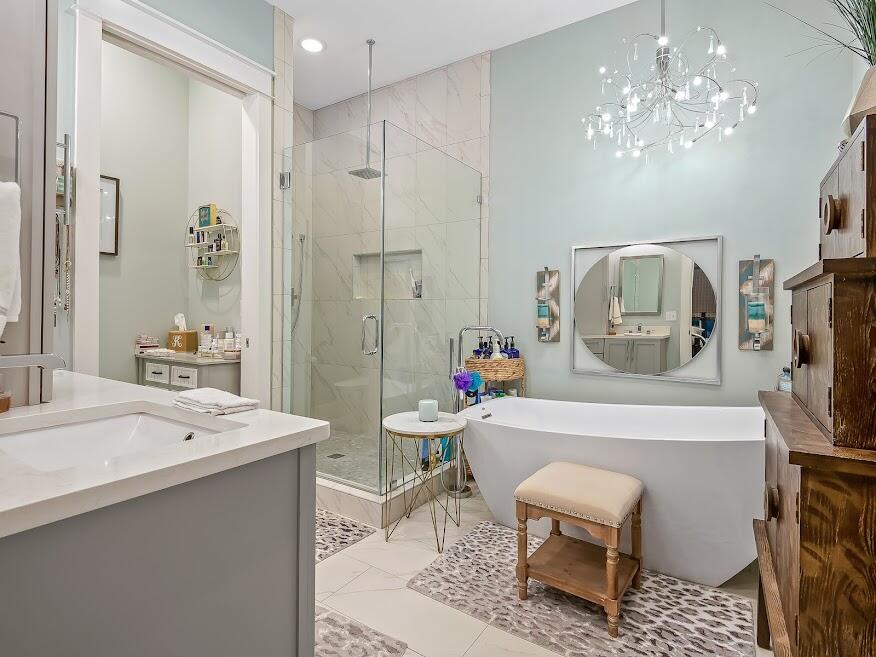 277 Matt's Way Santa Rosa Beach, FL 32459 - Photo 17 of 37 a spacious bathroom with a sink a mirror a bathtub and a chandelier