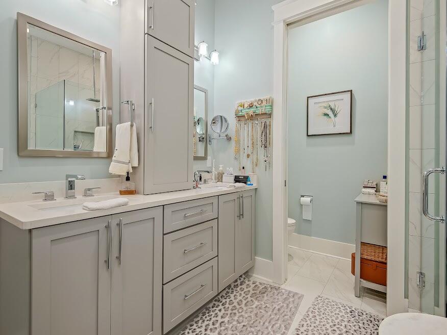 277 Matt's Way Santa Rosa Beach, FL 32459 - Photo 18 of 37 a spacious bathroom with a double vanity sink a mirror and a toilet