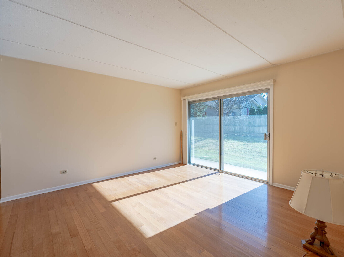 5818 Wolf Road, Unit 1A Western Springs, IL 60558 - Photo 3 of 14 an empty room with wooden floor and windows