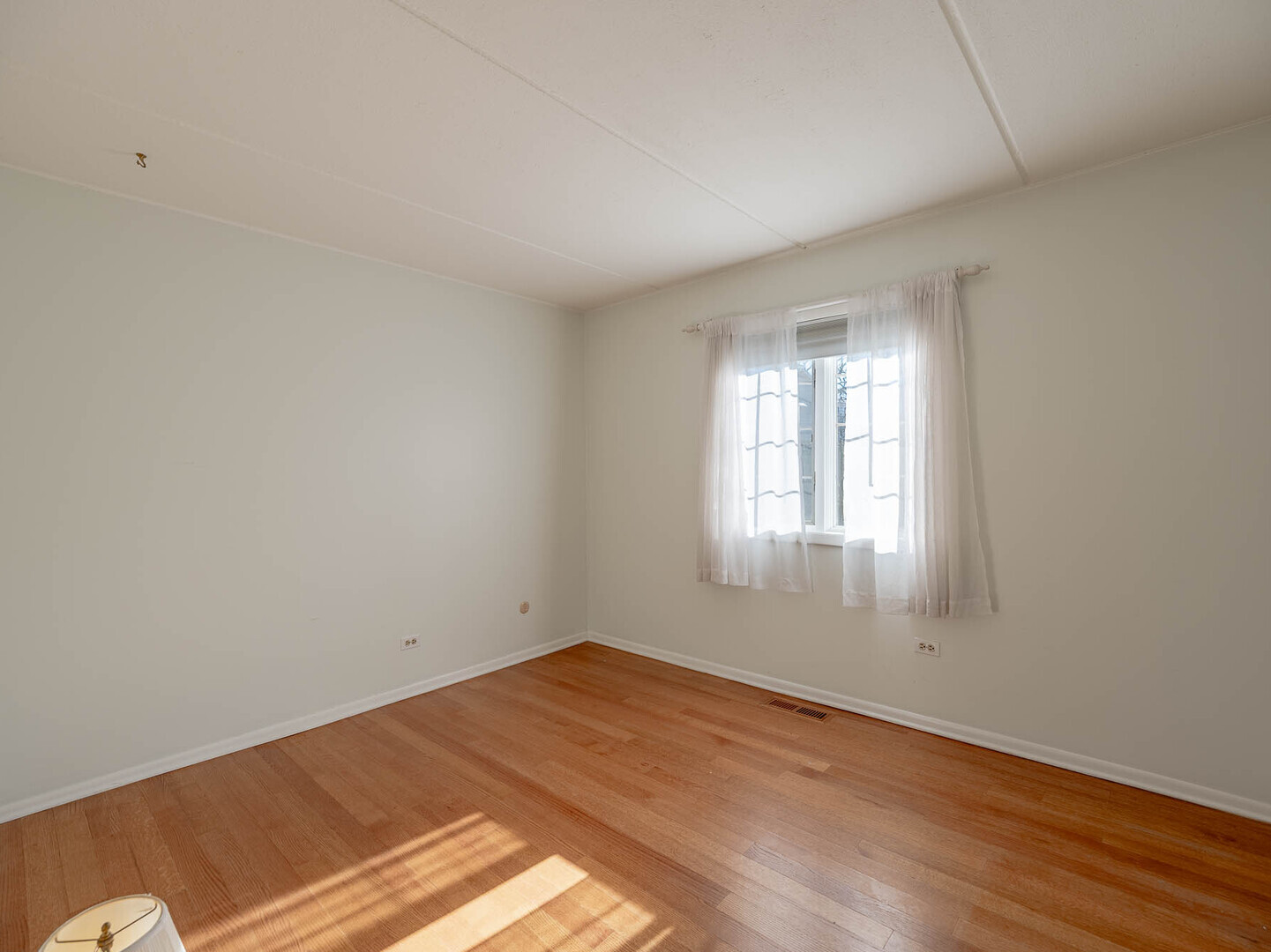 5818 Wolf Road, Unit 1A Western Springs, IL 60558 - Photo 7 of 14 an empty room with wooden floor and windows