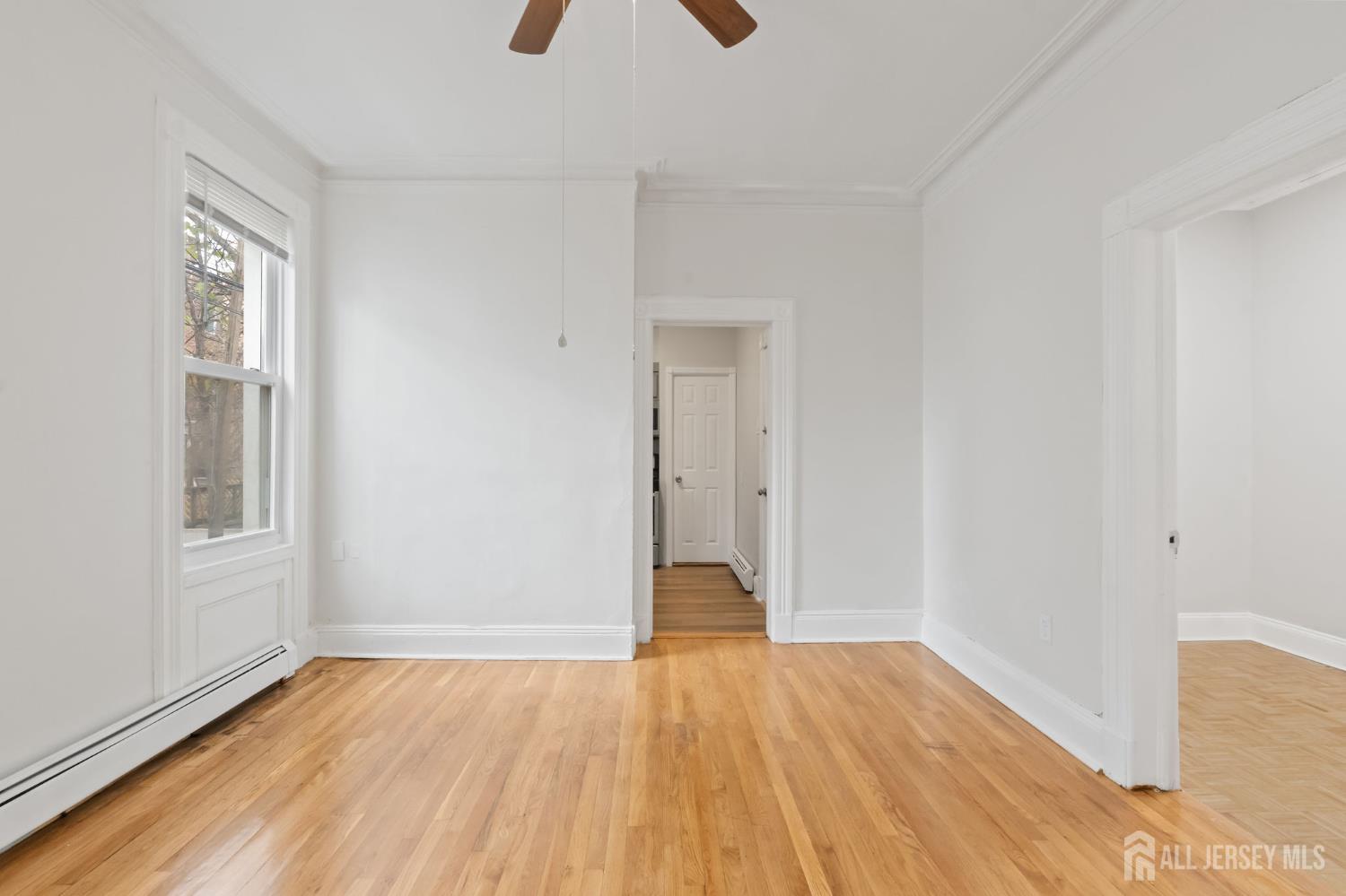20 Linden Court, Unit 1 Jersey City, NJ 07305 - Photo 11 of 33 wooden floor in an empty room with a window
