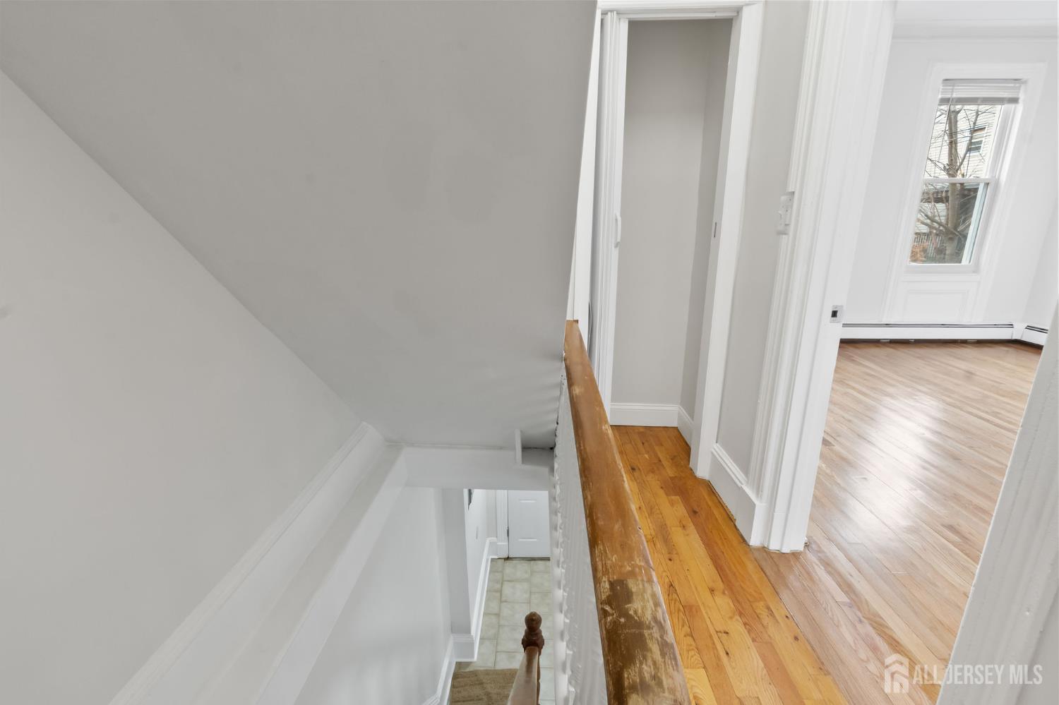 20 Linden Court, Unit 1 Jersey City, NJ 07305 - Photo 17 of 33 a view of a hallway with wooden floor and staircase
