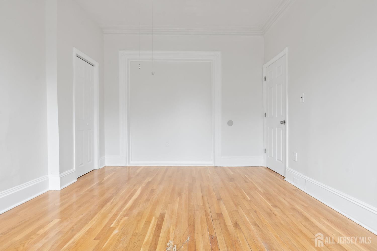 20 Linden Court, Unit 1 Jersey City, NJ 07305 - Photo 20 of 33 a view of a room with wooden floor and white walls