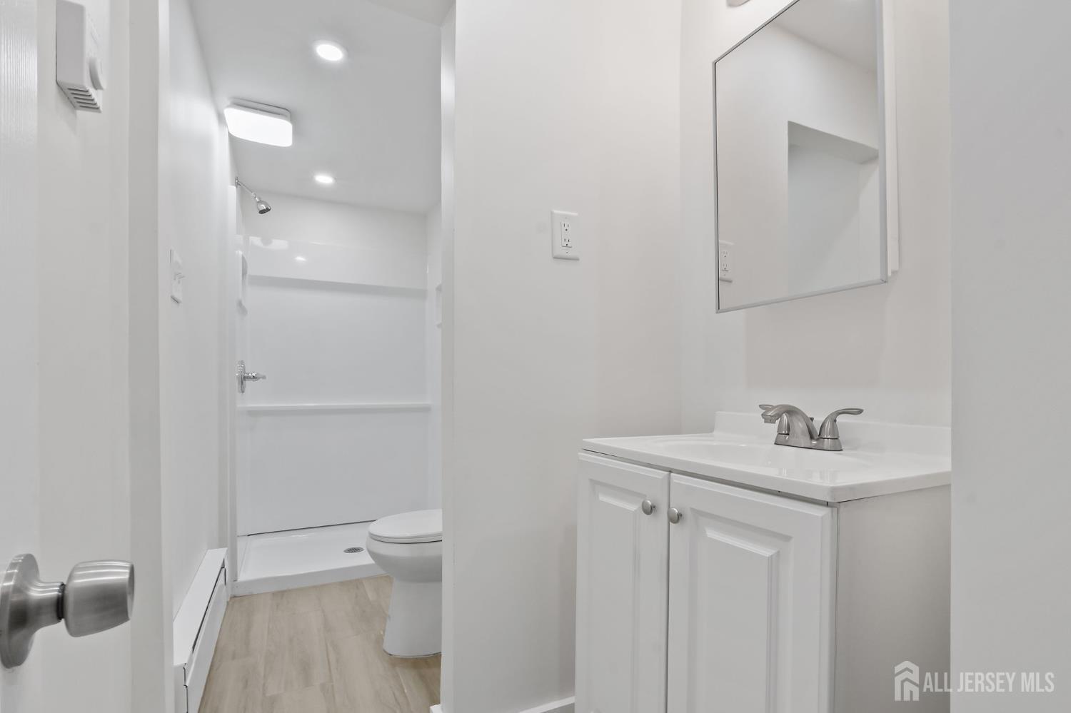 20 Linden Court, Unit 1 Jersey City, NJ 07305 - Photo 29 of 33 a bathroom with a sink toilet and vanity