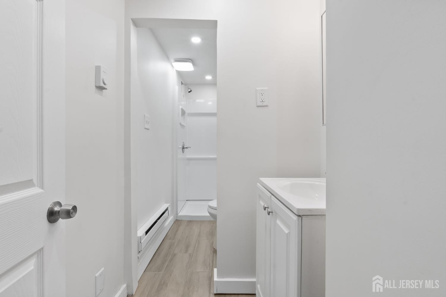 20 Linden Court, Unit 1 Jersey City, NJ 07305 - Photo 30 of 33 a bathroom with a sink a toilet and shower
