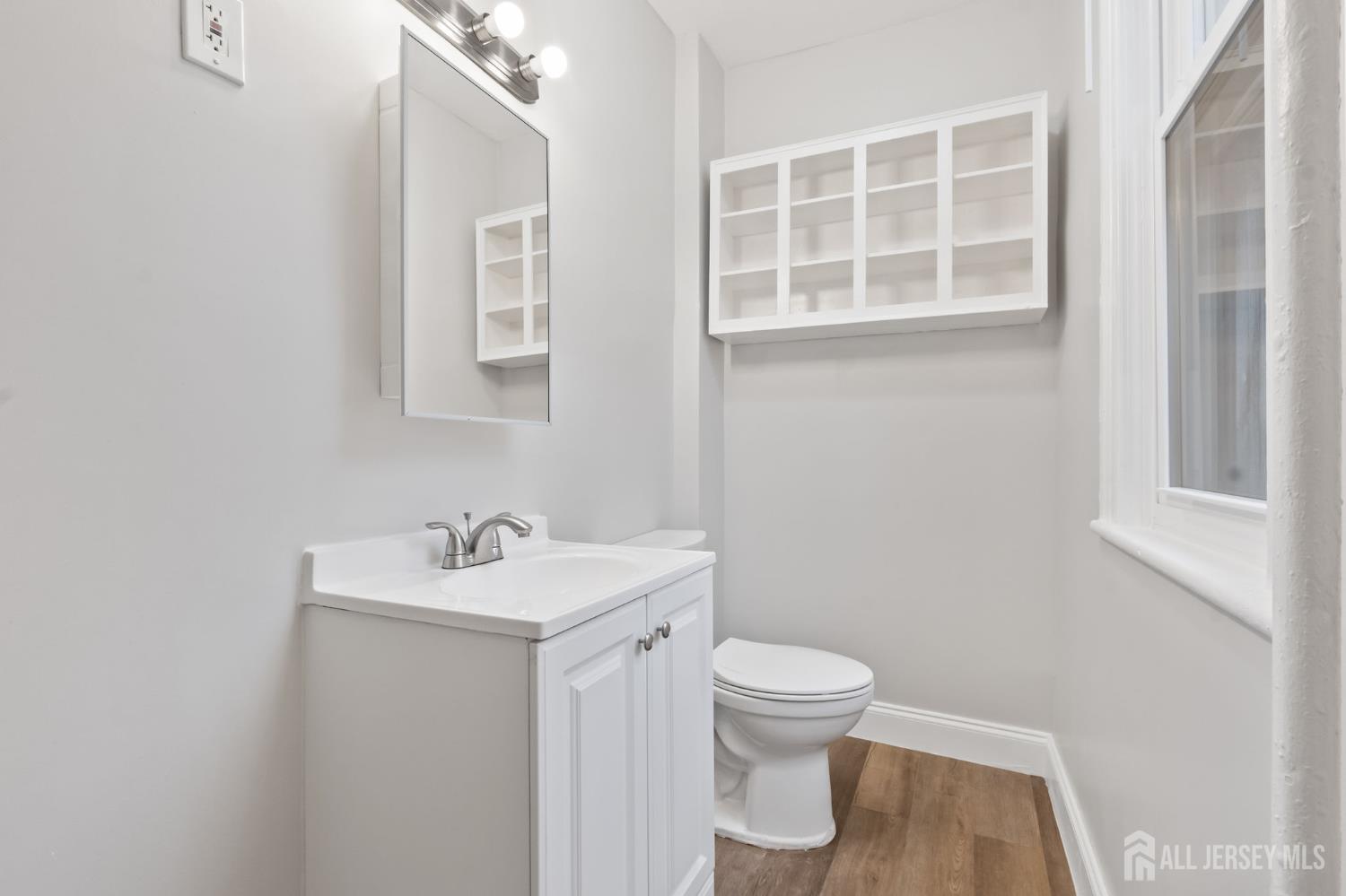 20 Linden Court, Unit 1 Jersey City, NJ 07305 - Photo 3 of 33 a bathroom with a sink toilet and a mirror