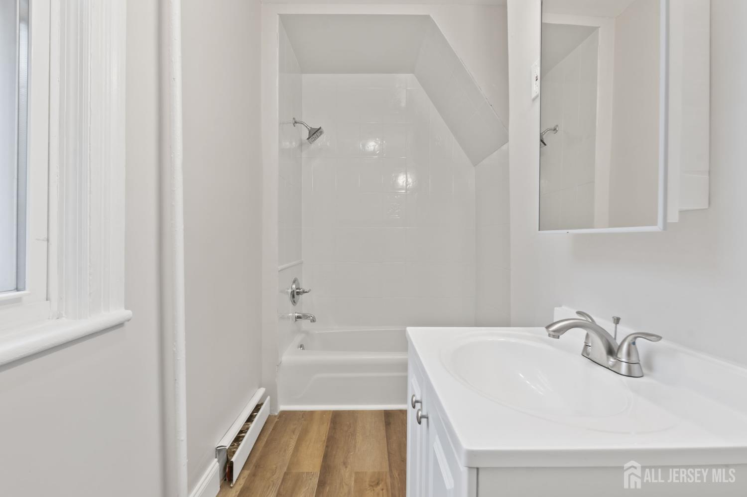 20 Linden Court, Unit 1 Jersey City, NJ 07305 - Photo 4 of 33 a bathroom with a sink and a bathtub