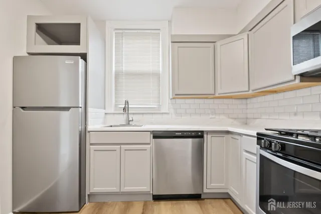 a kitchen with a sink and a refrigerator