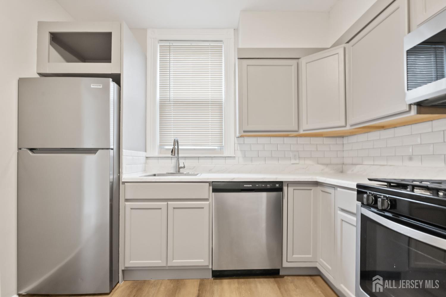 20 Linden Court, Unit 1 Jersey City, NJ 07305 - Photo 6 of 33 a kitchen with a sink and a refrigerator