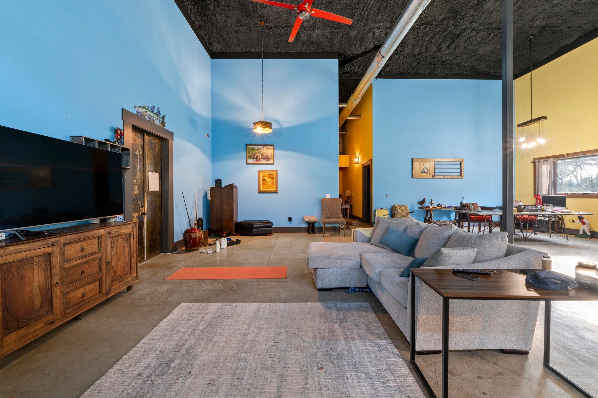 12302 Bethel Church Road Manchaca, TX 78652 - Photo 13 of 35 Living room featuring a high ceiling, ceiling fan, and concrete floors