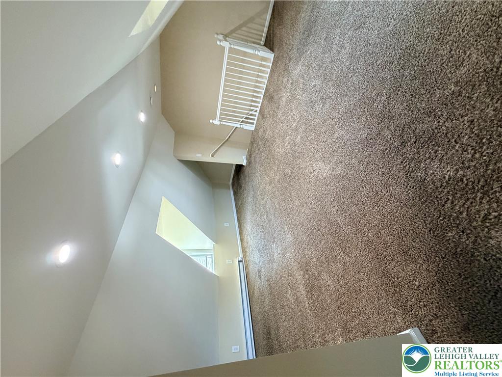 718 Ferry Street Easton, PA 18042 - Photo 24 of 37 A well-lit landing provides access to upper levels, highlighted by a clean carpeted floor.