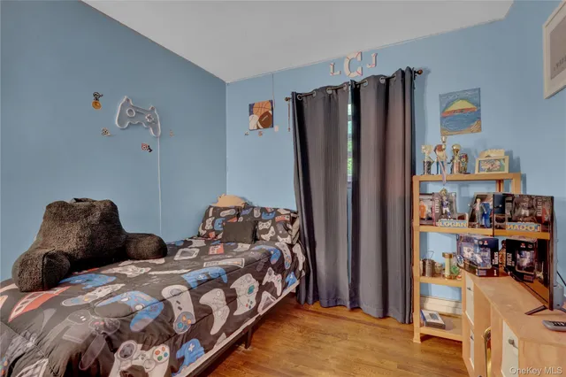 a bedroom with a bed and a book shelf