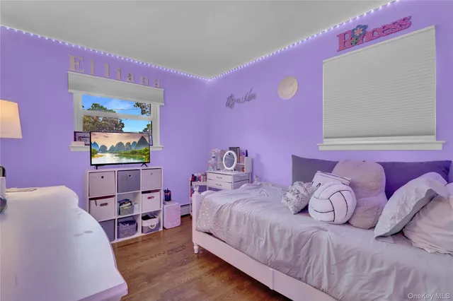 a bedroom with furniture and a wooden floor