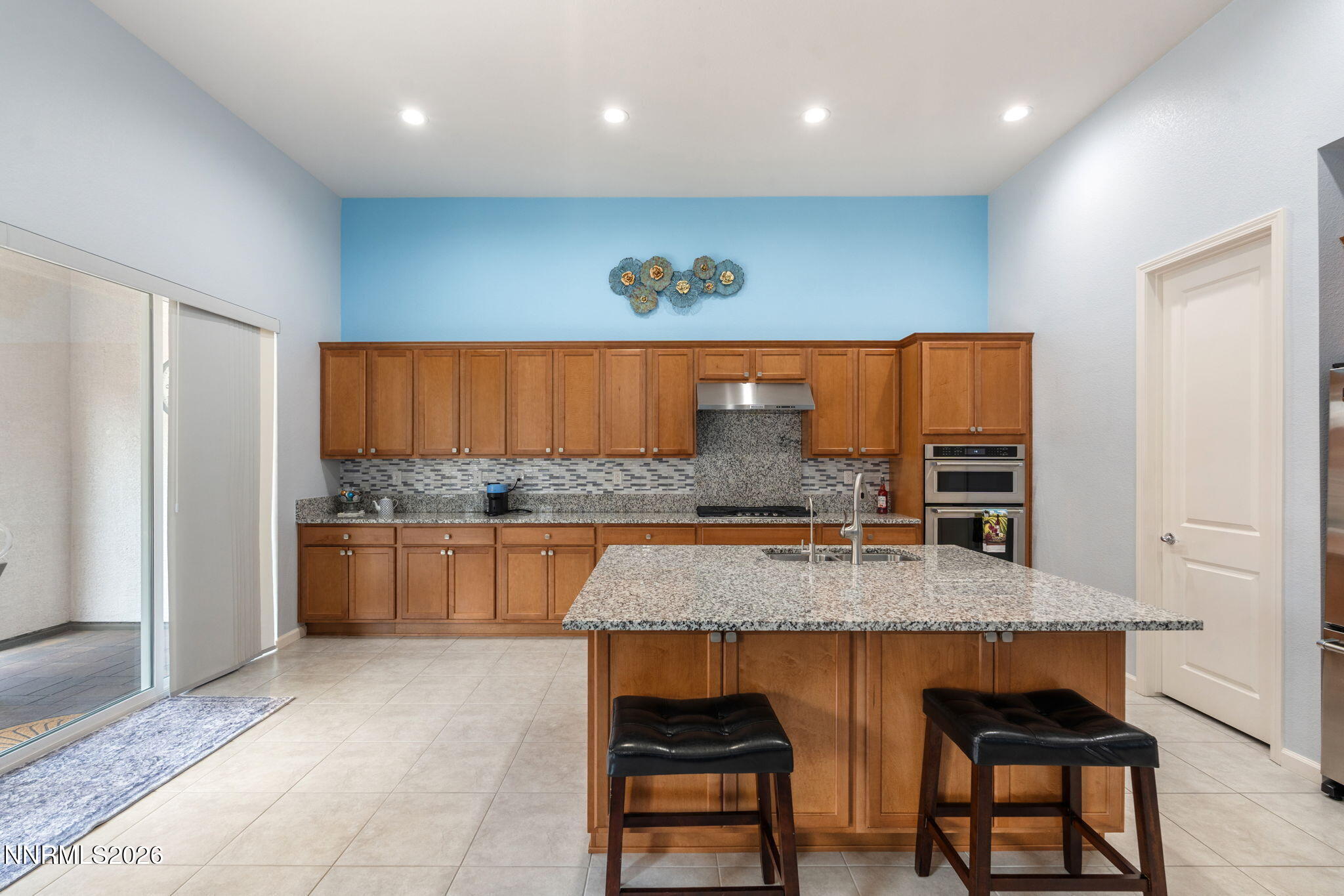 9401 Baldacci Road Reno, NV 89521 - Photo 7 of 42 a kitchen with stainless steel appliances granite countertop a stove a sink and a microwave