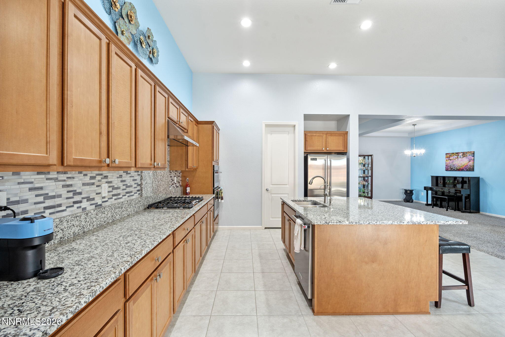 9401 Baldacci Road Reno, NV 89521 - Photo 9 of 42 a large kitchen with kitchen island granite countertop a sink and cabinets