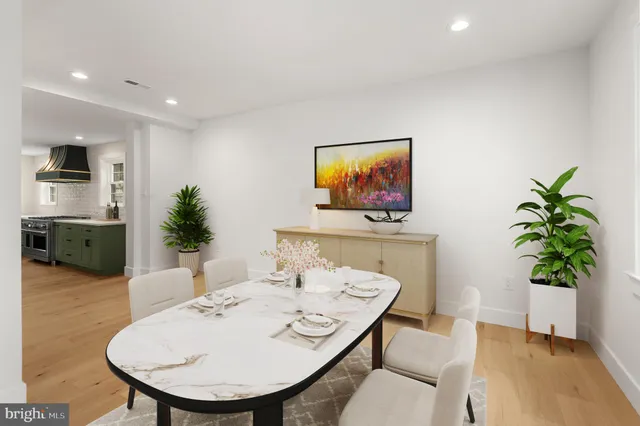 a living room with furniture potted plant and a flat screen tv