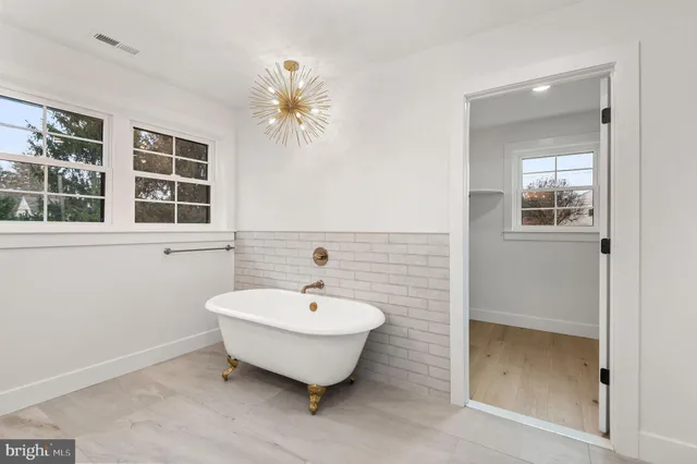 a spacious bathroom with a tub and a shower