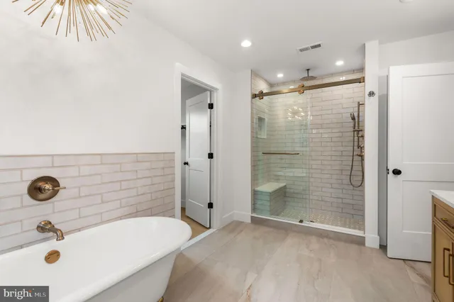 a bathroom with a sink a toilet a glass door shower