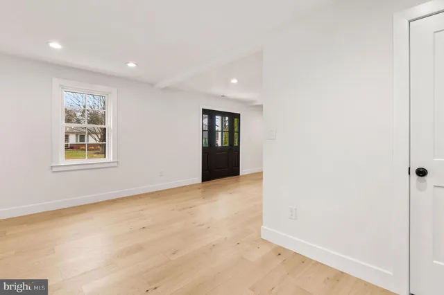 an empty room with windows and closet