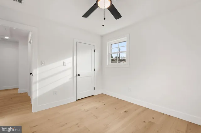 an empty room with a ceiling fan