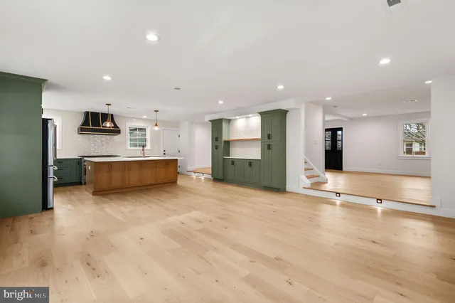 a view of a kitchen with a sink and a refrigerator