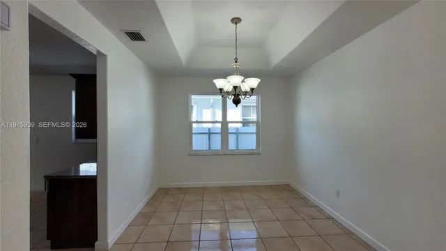 a view of a chandelier in big room and chandelier