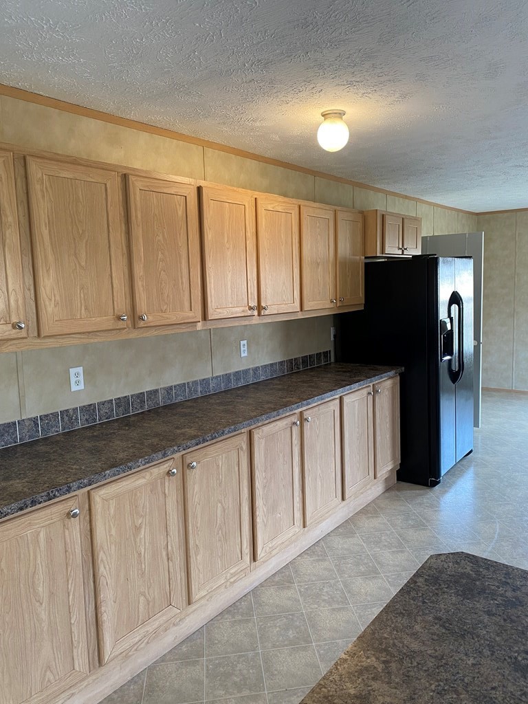 175 Fairview Road Athens, TN 37303 - Photo 26 of 46 a kitchen with granite countertop white cabinets and refrigerator