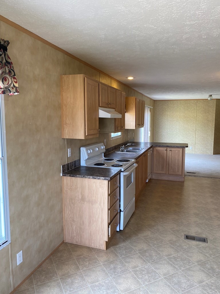 175 Fairview Road Athens, TN 37303 - Photo 30 of 46 a kitchen with stainless steel appliances granite countertop a stove a sink and a microwave