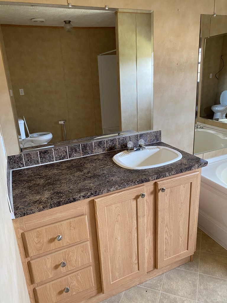 175 Fairview Road Athens, TN 37303 - Photo 35 of 46 a bathroom with a granite countertop sink and a mirror
