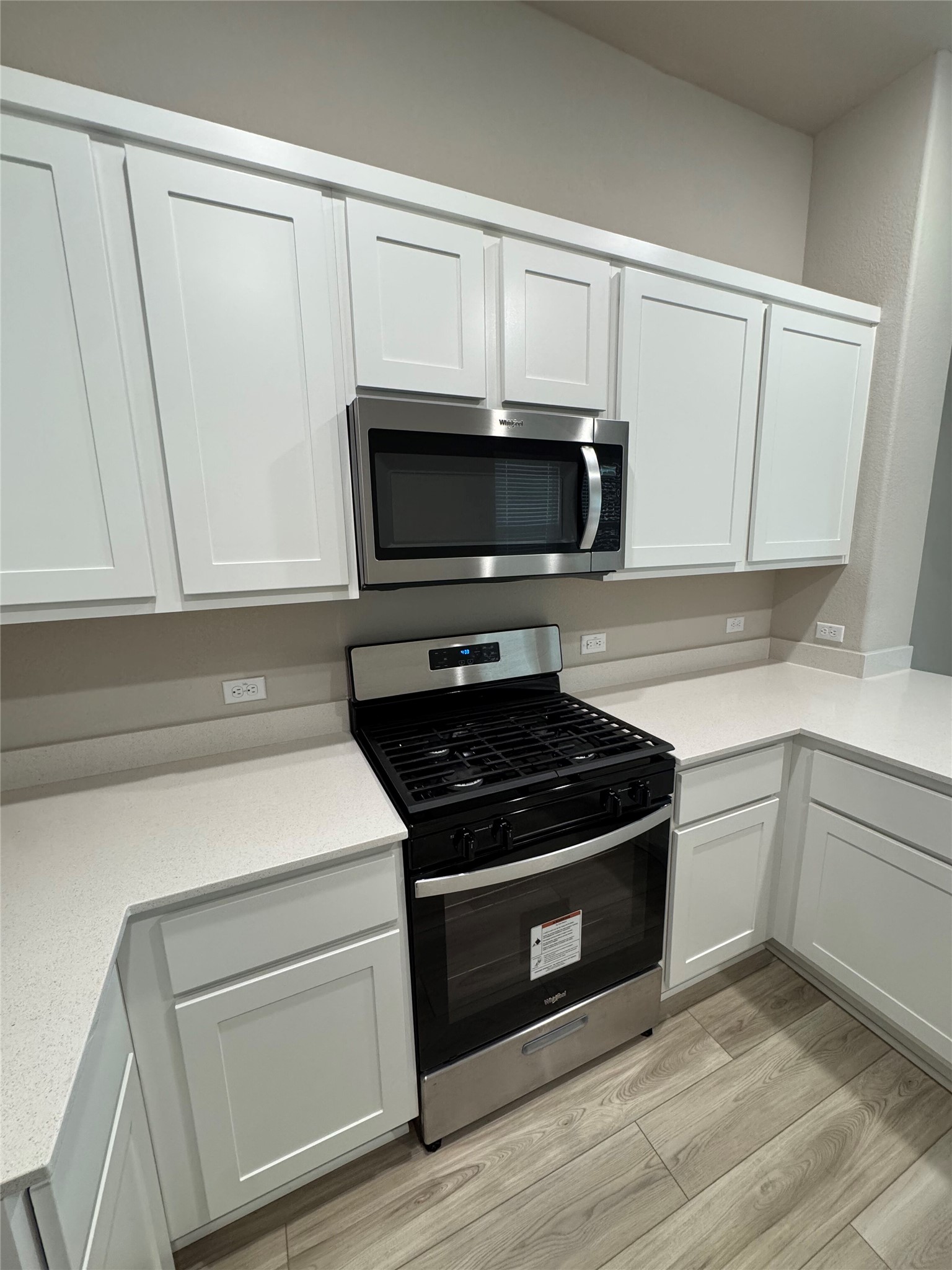 108 Bendecido Loop Elgin, TX 78621 - Photo 4 of 14 a kitchen with white cabinets and appliances