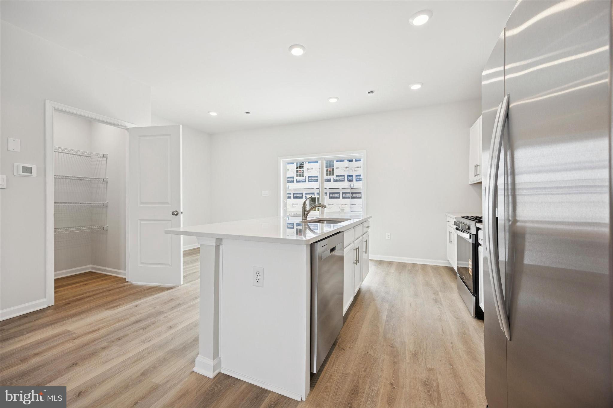 163 Sandy Rdg Road Sicklerville, NJ 08081 - Photo 11 of 30 a kitchen with stainless steel appliances a refrigerator and a wooden floor