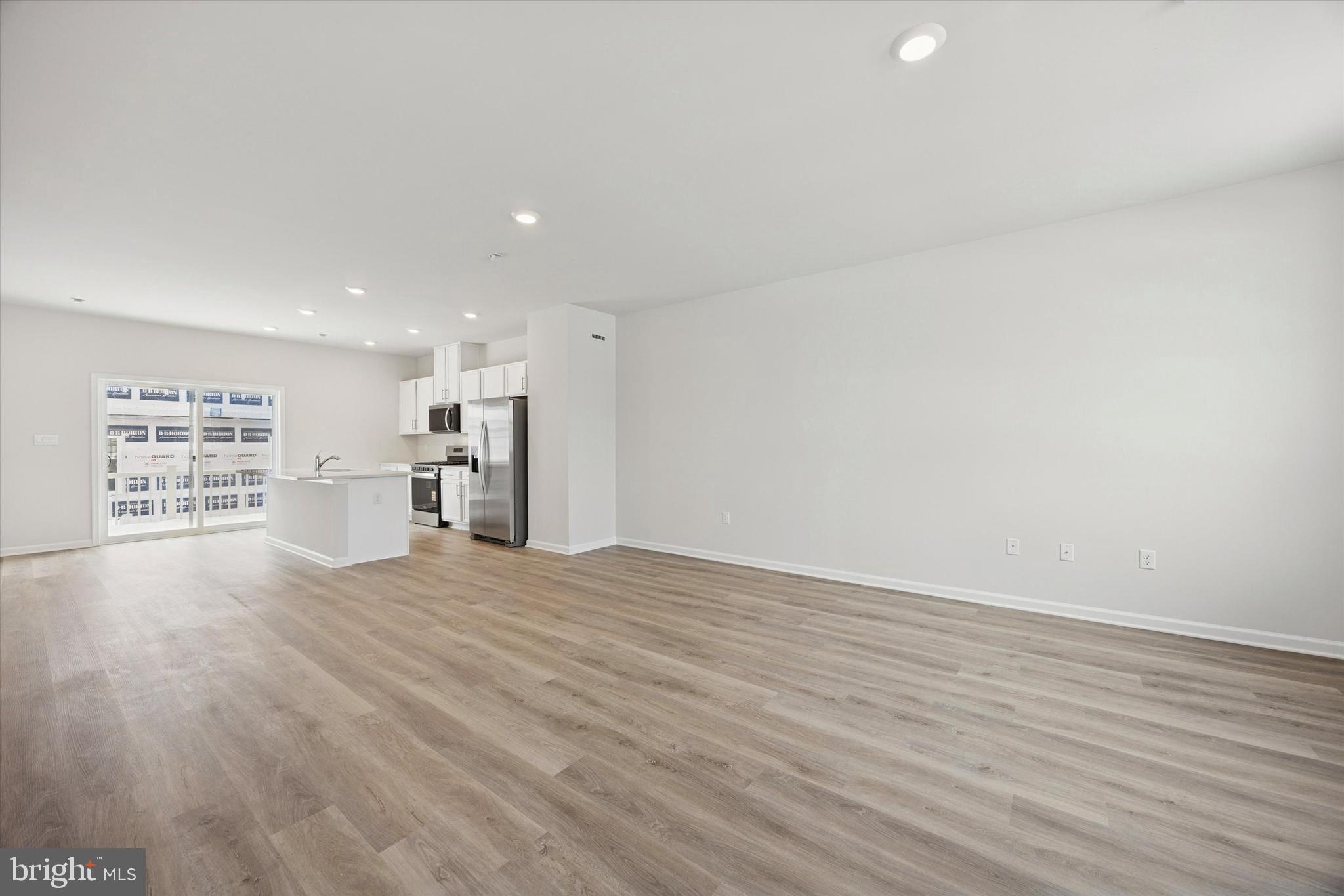 163 Sandy Rdg Road Sicklerville, NJ 08081 - Photo 16 of 30 a view of kitchen and empty room with wooden floor